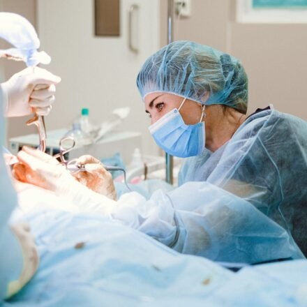 Woman Doing a Surgery on a Patient